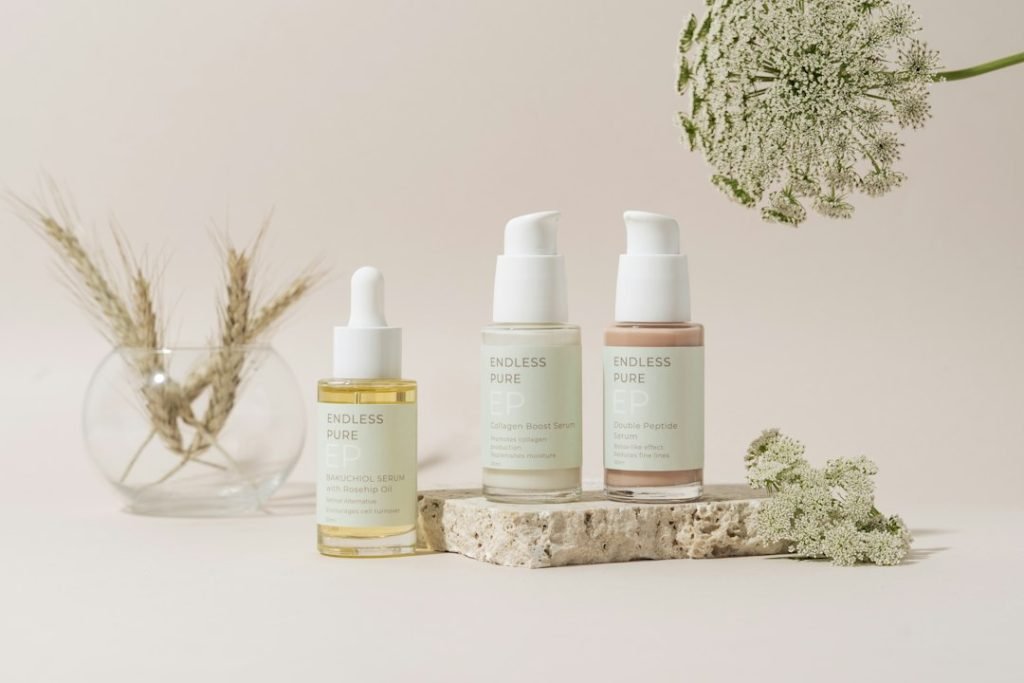 An elegantly organized collection of skincare products showcased on a marble tray, set against a soft beige backdrop. The minimalistic design and muted tones create a sophisticated and serene ambiance, highlighting the luxurious essence of the products.